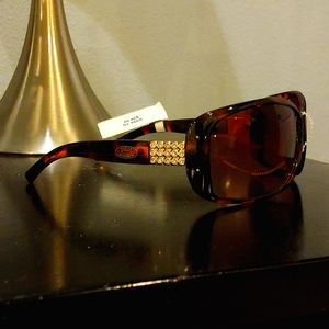 Two pair of sunglasses, one Steve Madden and one Jessica Simpson pair.